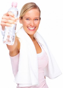 Young beautiful woman holding a bottle of water isolated over white background